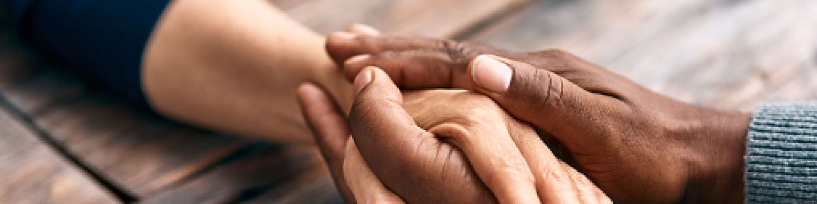 patient holding hands with loved one
